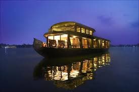 Family enjoying breakfast on the deck of a Kerala houseboat
