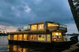 Traditional Alleppey houseboat moored on Vembanad Lake at sunset